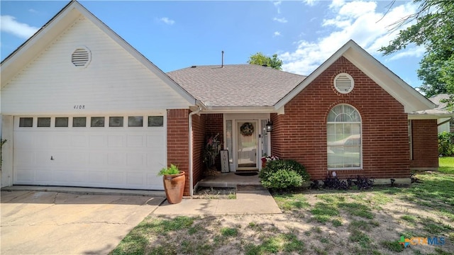 4108 Red River Cir, Temple, TX 76504 - view of front of home with brick siding, an attached garage, driveway, and a shingled roof