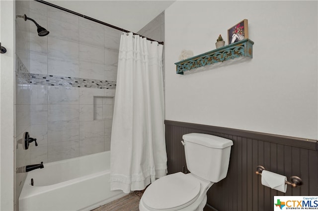 bathroom with shower / bath combo with shower curtain, wooden walls, and toilet