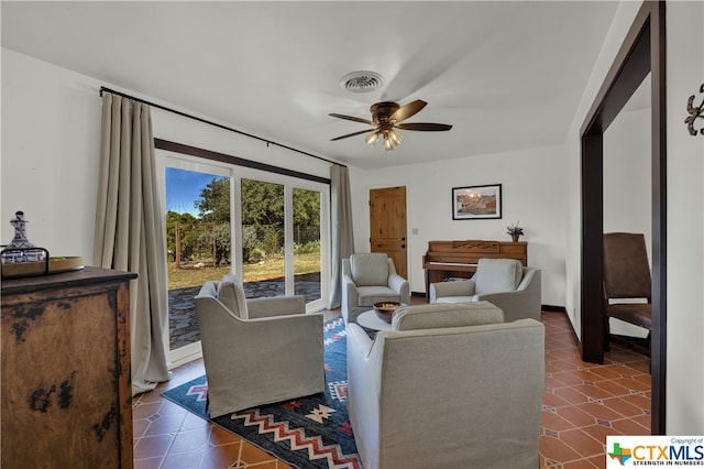 tiled living room with ceiling fan