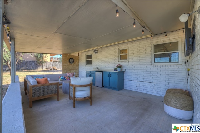 view of patio featuring an outdoor living space and sink