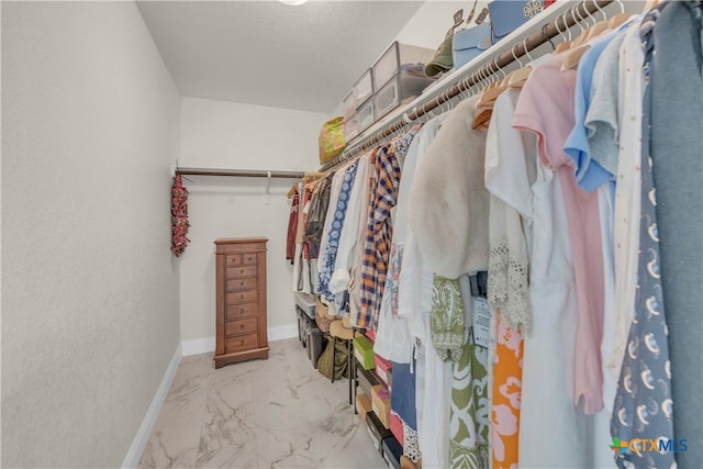 spacious closet with marble finish floor