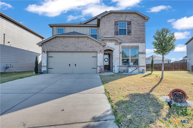 view of front of house featuring driveway, fence, a front yard, a garage, and brick siding