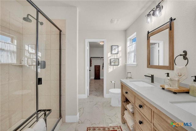 bathroom featuring a shower stall, baseboards, marble finish floor, and a sink