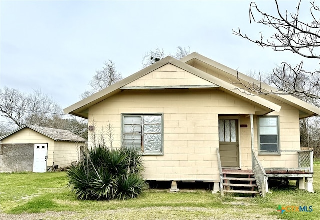 rear view of house with a yard