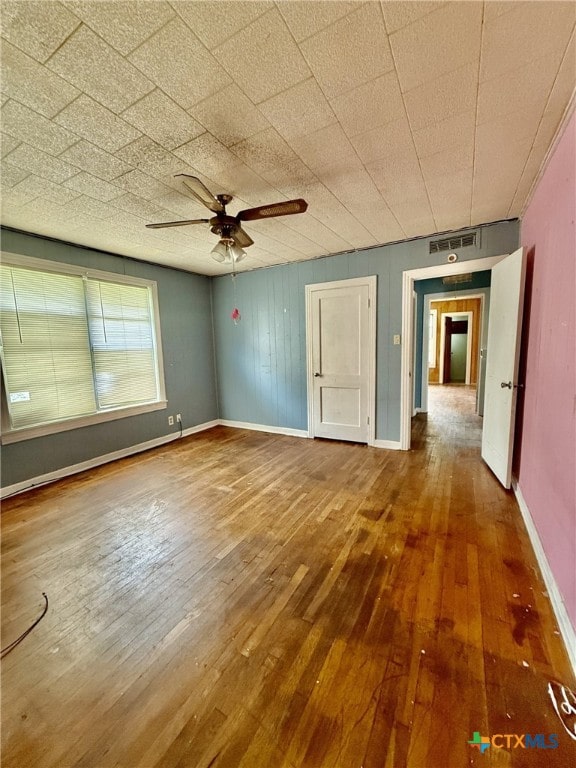 empty room featuring ceiling fan and wood-type flooring