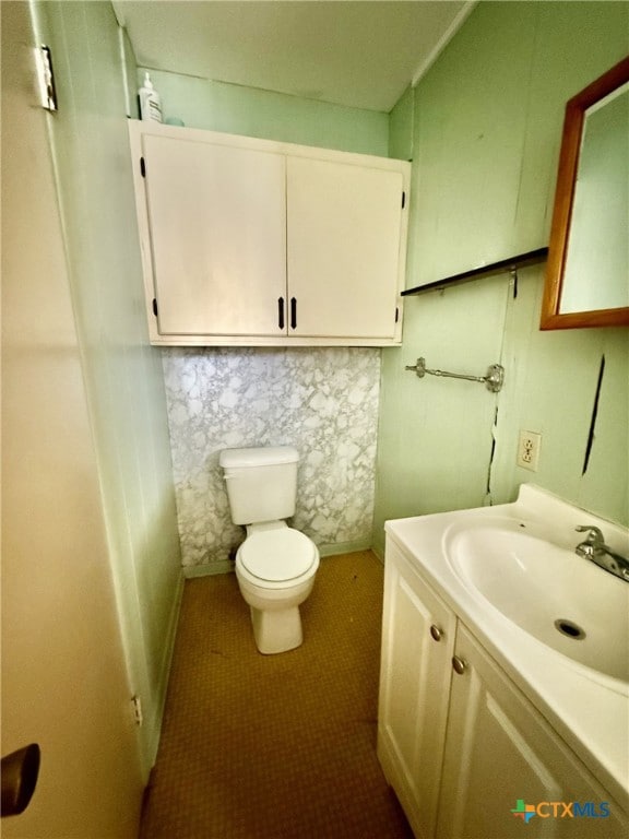 bathroom with tile patterned floors, toilet, and vanity