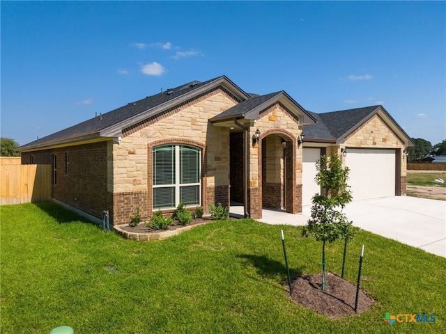 ranch-style home with a garage and a front lawn