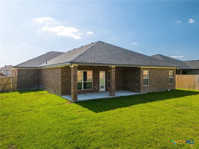 back of property featuring a lawn and a patio area