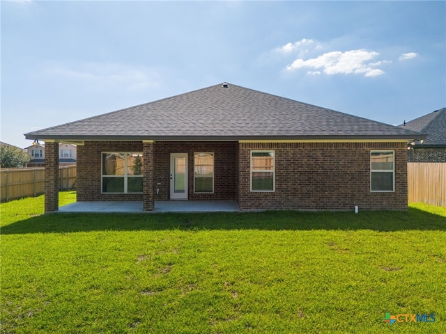 back of property featuring a patio and a yard