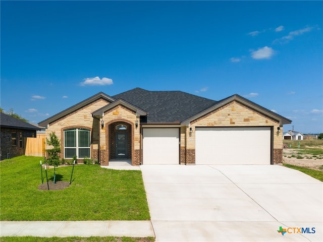 view of front of house featuring a garage and a front yard