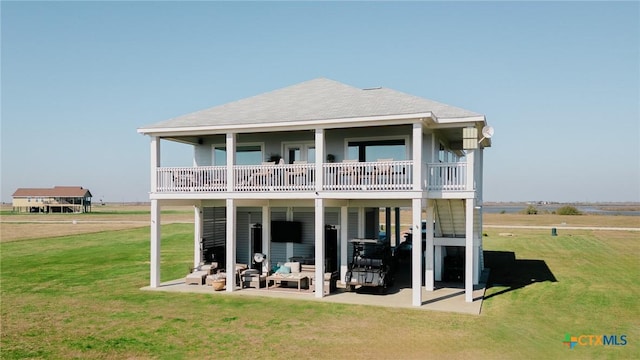 back of property featuring a patio and a lawn