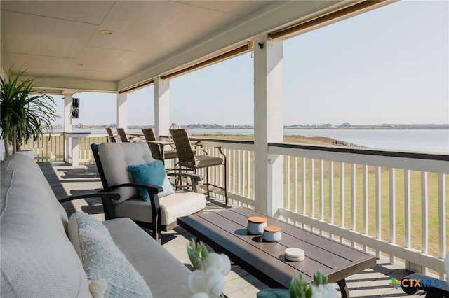 wooden deck with outdoor lounge area and a water view