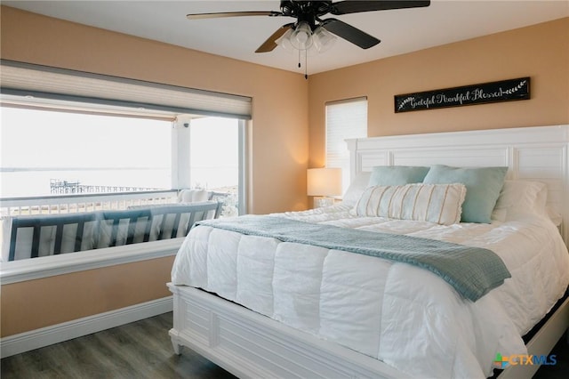 bedroom featuring ceiling fan and dark wood-type flooring