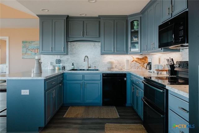 kitchen with dark wood-type flooring, black appliances, backsplash, sink, and kitchen peninsula