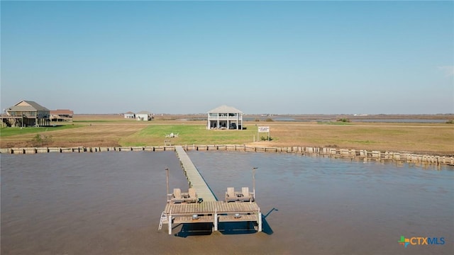 dock area with a rural view and a water view