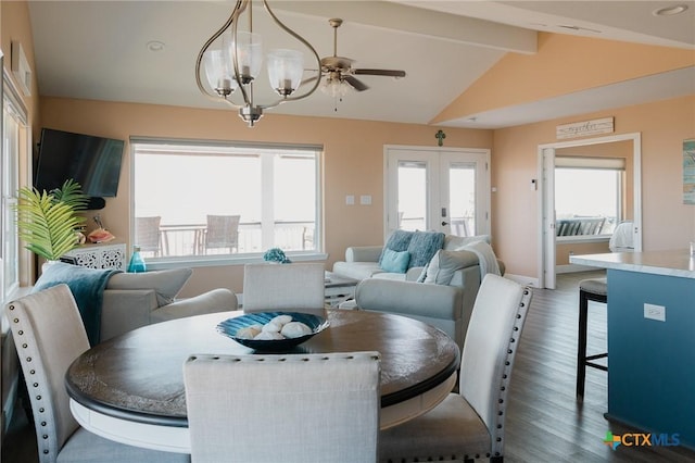 dining space with lofted ceiling with beams, dark hardwood / wood-style floors, french doors, and an inviting chandelier