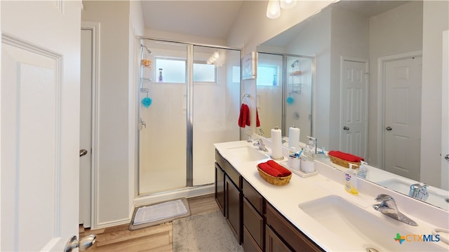 8915 Hidden Oaks Dr, Temple, TX 76502 - full bath featuring double vanity, a stall shower, and wood finished floors