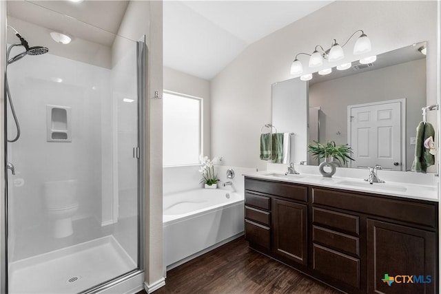 2020 Mallard Ct, Copperas Cove, TX 76522 - bathroom featuring a shower stall, wood finished floors, double vanity, lofted ceiling, and a bath