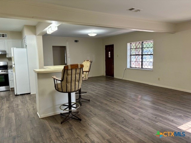 kitchen with white cabinets, dark hardwood / wood-style flooring, exhaust hood, and white refrigerator