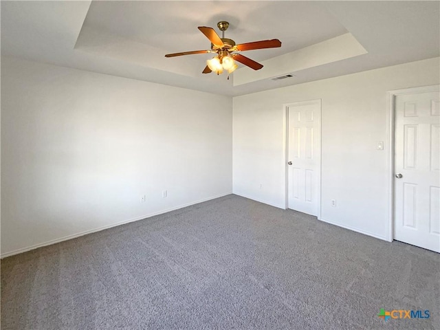 1116 Marlee Cir, Copperas Cove, TX 76522 - unfurnished bedroom with a raised ceiling, dark carpet, and ceiling fan