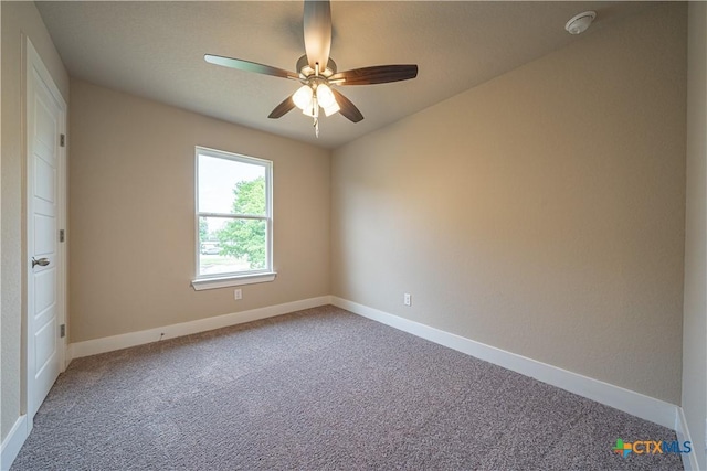 carpeted empty room with baseboards and ceiling fan