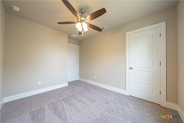 interior space featuring visible vents, carpet flooring, baseboards, and ceiling fan