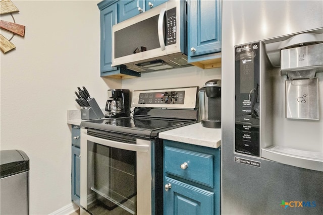 kitchen with blue cabinetry and stainless steel appliances