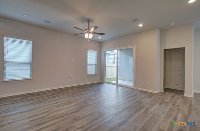 spare room featuring ceiling fan and light wood-type flooring