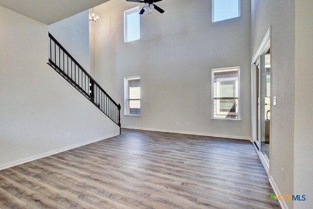 1236 Tuscan Vw, New Braunfels, TX 78130 - kitchen featuring stainless steel appliances, a sink, light wood-style flooring, an island with sink, and backsplash