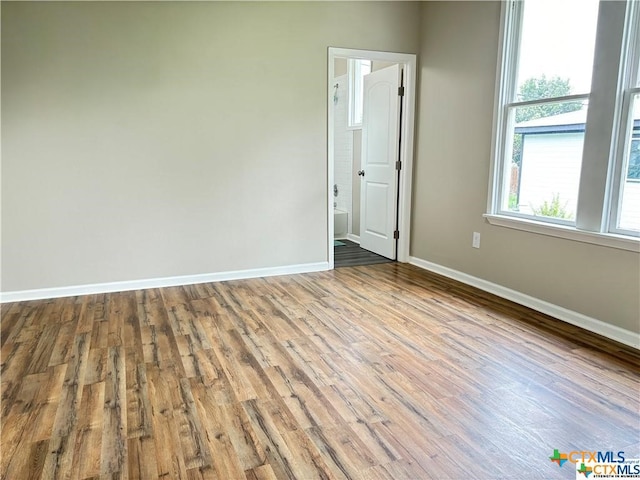 unfurnished room with light wood-type flooring