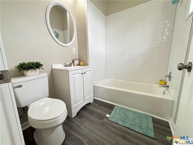 full bathroom with wood-type flooring, vanity, toilet, and tiled shower / bath