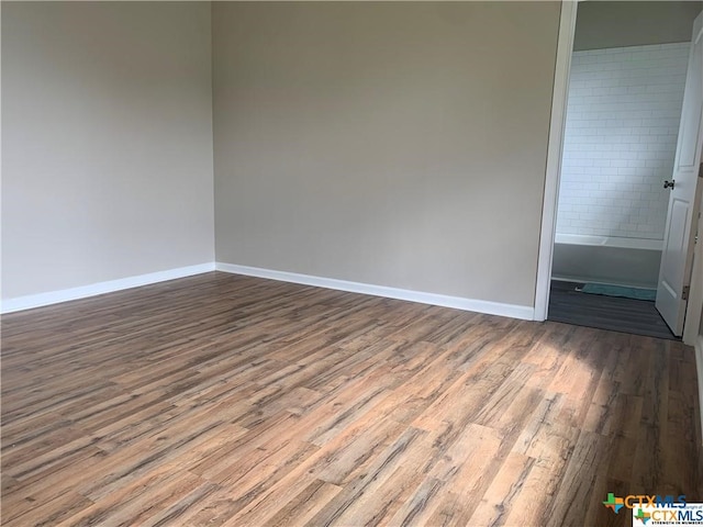 empty room with hardwood / wood-style floors