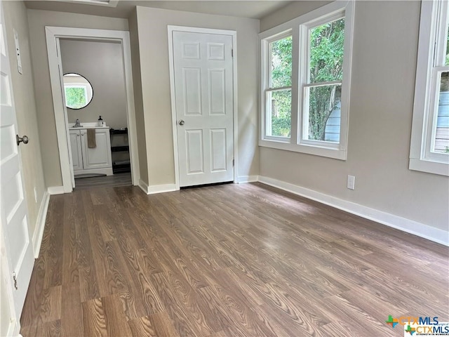 unfurnished bedroom with dark hardwood / wood-style floors