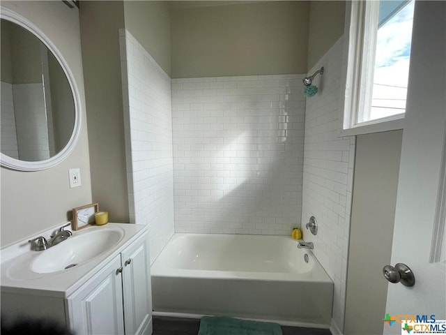 bathroom with vanity and tiled shower / bath combo