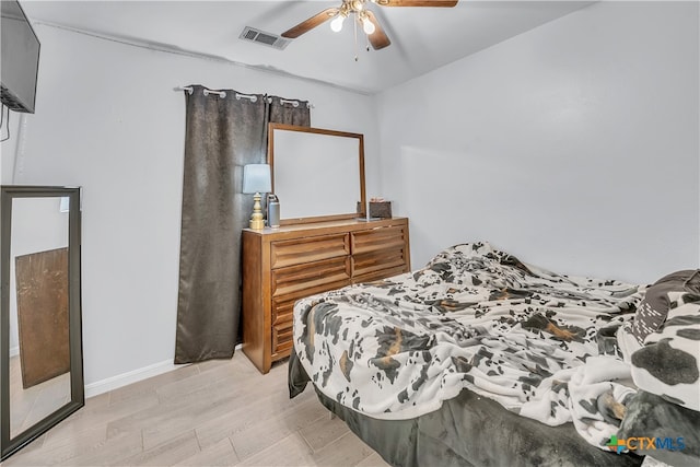 bedroom with ceiling fan and light hardwood / wood-style flooring