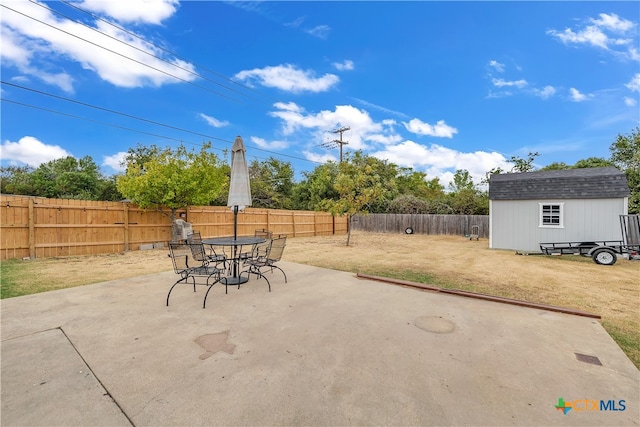 view of patio with a storage shed