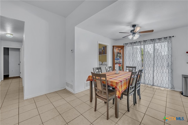 tiled dining area with ceiling fan