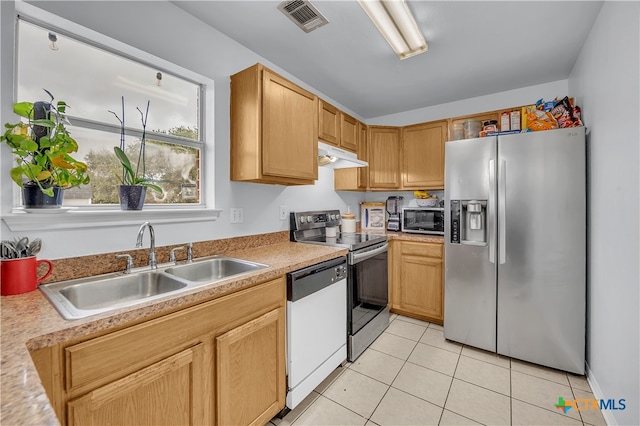 kitchen featuring appliances with stainless steel finishes, sink, and light tile patterned floors