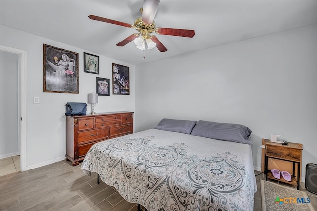 bedroom with light wood-type flooring and ceiling fan