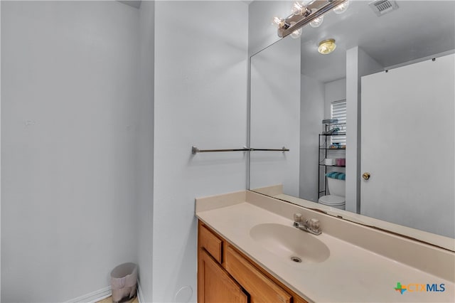 bathroom featuring vanity and toilet