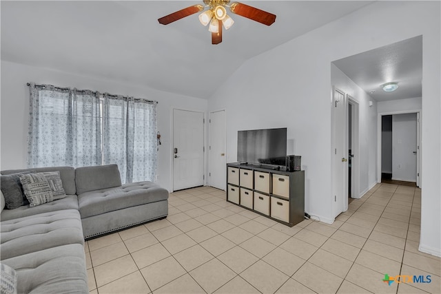 living room featuring ceiling fan, vaulted ceiling, and light tile patterned flooring