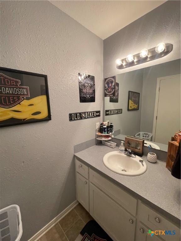 110 Idylwood Pl, Victoria, TX 77901 - bathroom featuring vanity, tile patterned flooring, a textured wall, and baseboards