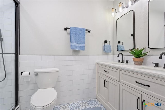 2302 Brooklawn Dr, Temple, TX 76502 - full bathroom featuring tile walls, double vanity, tiled shower, a wainscoted wall, and baseboard heating