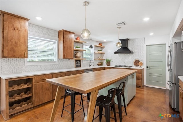 2302 Brooklawn Dr, Temple, TX 76502 - kitchen with wall chimney range hood, open shelves, gas cooktop, freestanding refrigerator, and backsplash