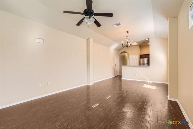 101 Creekside Villa Dr, Kyle, TX 78640 - unfurnished living room with arched walkways, dark wood-type flooring, ceiling fan, vaulted ceiling, and a chandelier
