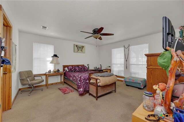 bedroom featuring light carpet and ceiling fan