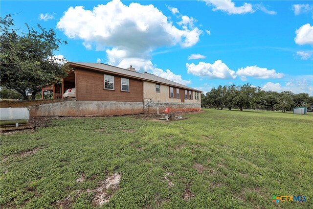 rear view of house with a lawn