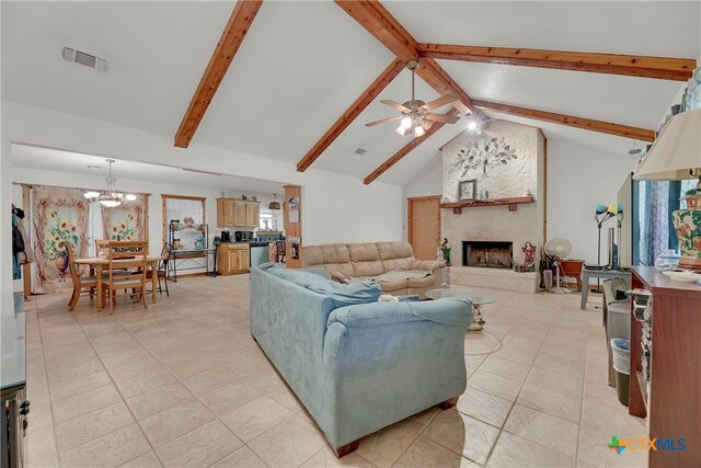 tiled living room with a fireplace, ceiling fan with notable chandelier, beam ceiling, and high vaulted ceiling