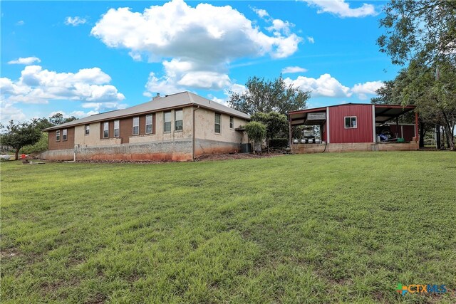 rear view of house with a lawn