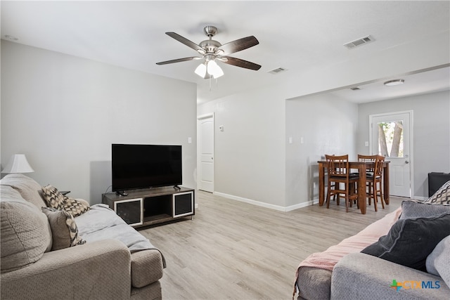 living room with light hardwood / wood-style flooring and ceiling fan